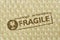 The word Fragile on plastic bubble wrap background - Concept of protective packaging wrapping solutions