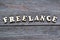 Word freelance. Wooden lettering on top of wooden background. Human Resource Management and Recruitment and Hiring concept.