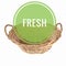 the word fresh in a green circle in a wicker basket