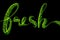 The word Fresh made of luminous and sparkling round green particles isolated on black background