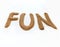 The word `FUN` written by sand on white background.