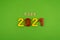 The word goal 2021 is lined with wooden letters on a green background. Figures from the constructor top view. Postcard