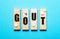 The word GOUT is written on wooden blocks on a blue background next to the pills. Medical concept