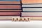 The word grant on wooden cubes with stacked books background. Education or research funding concept