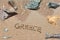 The word Greece written in the sand on beach