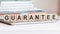 the word guarantee is written on wooden cubes, concept