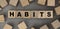 The word HABITS made from wooden cubes. Conceptual photo