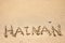 Word Hainan written in the sand seashore of tropical beach