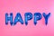 Word HAPPY made of blue foil balloon letters on background