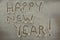 The word happy new year written on sprinkled flour