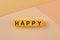 The word HAPPY written on yellow cubes close up.