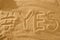 Word with hashtag yes in the sand against sea sun. concept symbol of holiday.