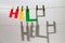 Word `Help` from different color letters is hanging at the rope on the grey background. International Volunteer Day