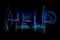 The word \'Help\' written with light motion trails in neon colours