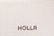 The word Holla written with coffee beans shot from above, aligned at the bottom