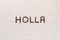 The word Holla written with coffee beans shot from above, aligned in the center, closeup