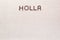 The word Holla written with coffee beans shot from above, aligned at the top