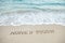 Word honeymoon written on beach