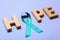 Word Hope made of wooden letters and teal awareness ribbon. Symbol of social and medical issues