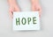 The word hope is standing on a paper, positive mindset