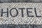 Word Hotel on a Typical Mosaic Floor in Lisbon Street, Portugal