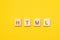 Word HTML made from wooden letters on yellow background. Programming language for web site development