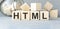 word HTML on wooden cubes, code concept