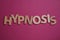 Word HYPNOSIS made with letters on magenta background, flat lay