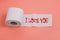 The word I LOVE YOU written on toilet paper. Valentine`s day concept. Romantic quote for the design of greeting cards, holiday