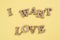 Word I want love abstract wooden letters, yellow background.