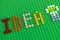 Word Idea and light bulb spell out from Lego Round Bricks on green baseplate