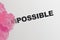 Word Impossible turning into Possible with pink smoke. Startup business motivation concept