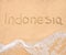 The word Indonesia written in the sand on beach