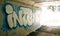 The word `intent` in graffiti on the concrete walls of a highway underpass