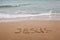 Word Jesus written on the sand