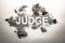 Word judge written in dirt, filth, ash, grime, dust as justice,