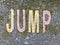 The word JUMP on the floor in a kids park