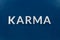 The word karma on classic blue background - on center of picture