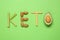 Word Keto made with different products on green background, flat lay