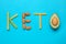 Word Keto made with different products on light blue background, flat lay