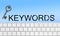 Word Keywords, computer keyboard and key on blue background. SEO direction