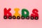Word kids made of letters train alphabet. Bright colors of red yellow green and blue on a white background. Early childhood develo