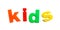 Word KIDS of magnetic letters on white, top view