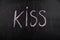 Word kiss on black chalkboard