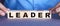 The word leader is made up of wooden cubes