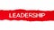 The word LEADERSHIP appearing behind red torn paper