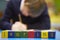 Word Learning Spelt In Wooden Blocks With Pupil Behind