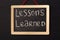 Word lessons learned written on miniature chalkboard