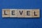 word level from small gray wooden letters