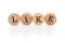 Word Like from circular wooden tiles with letters children toy.